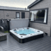 Oasis Range Hot Tub 13AMP. 2 loungers 3 seats. Hot tub sunk into decking